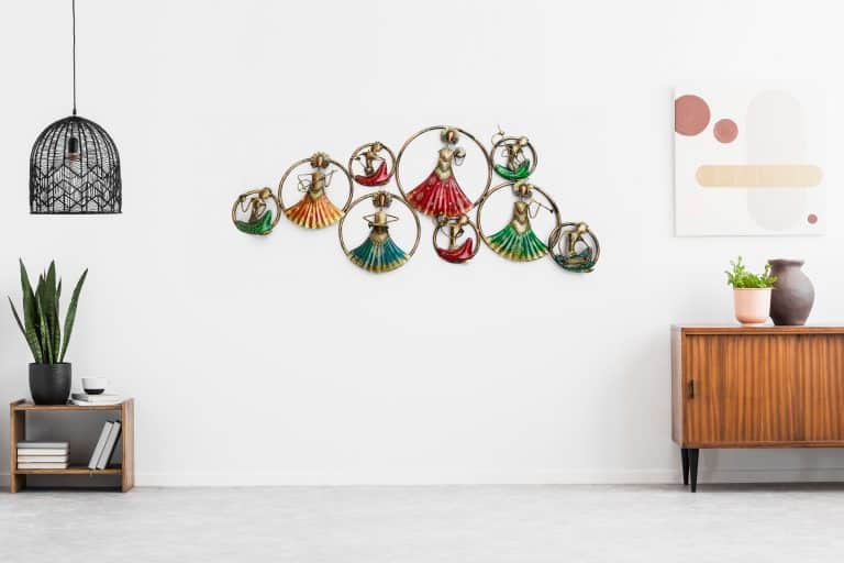 Retro, wooden cabinet and a painting in an empty living room int